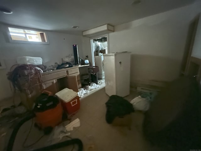 29 Tree Hill Rd, Waterbury, CT 06708 - below grade area with refrigerator and tile patterned floors