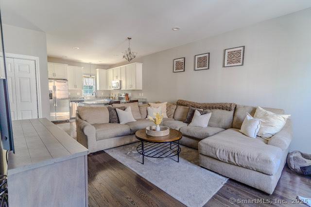 41 Eden Ave Unit 3, Southington, CT 06489 - living area with dark wood finished floors and a chandelier