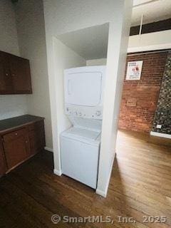 850 Grand Ave, New Haven, CT 06511 - laundry room with estacked washer and dryer, dark wood-type flooring, and brick wall