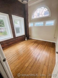 850 Grand Ave, New Haven, CT 06511 - unfurnished room featuring healthy amount of natural light and wood finished floors