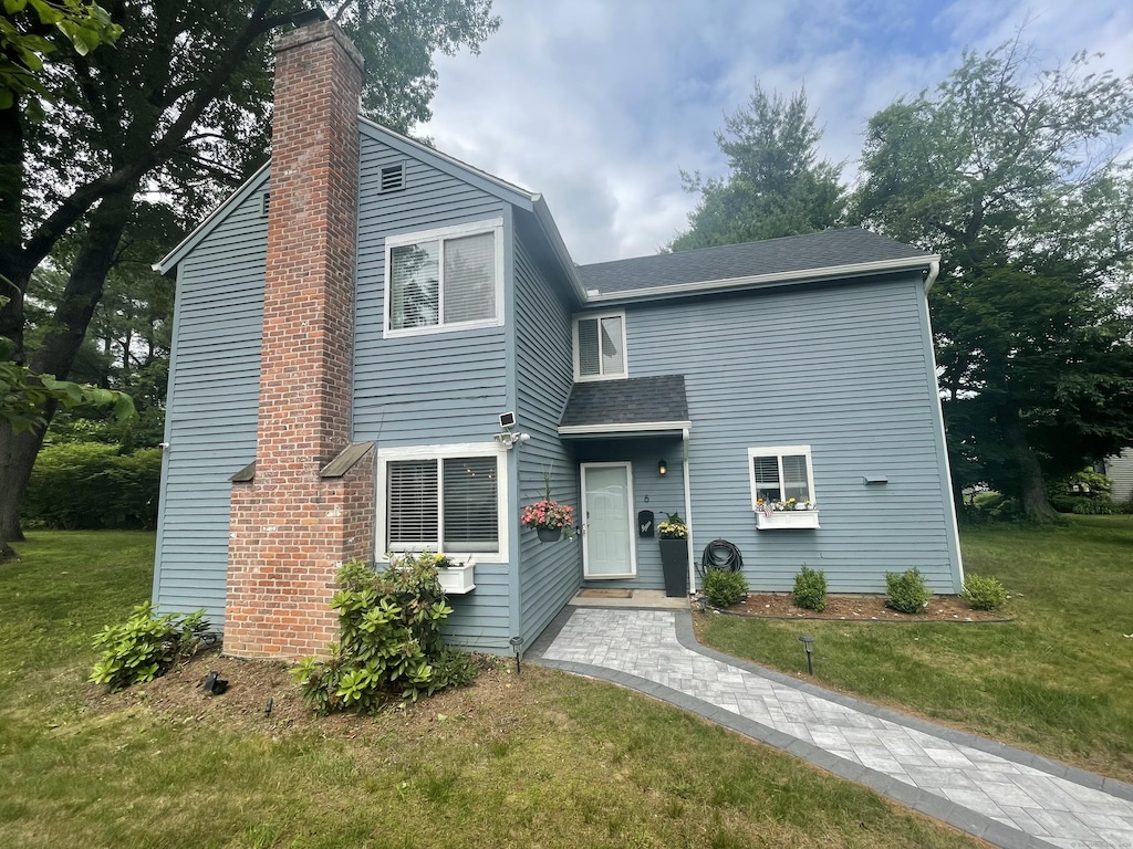 6 Mathers Xing Unit 6, Simsbury, CT 06070 - view of front of home featuring a chimney, a front lawn, and a shingled roof