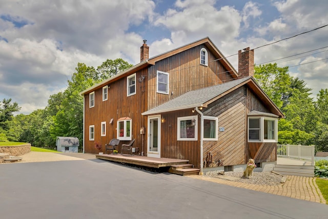 128 Holcomb Hill Rd, New Hartford, CT 06057 - view of front facade featuring a chimney and a deck