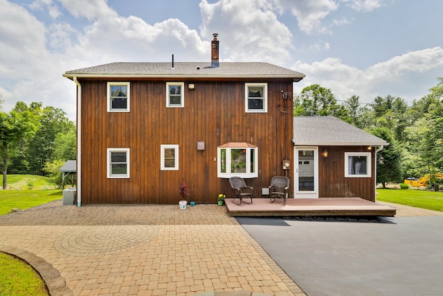 128 Holcomb Hill Rd, New Hartford, CT 06057 - rear view of house with a chimney, a wooden deck, a patio area, and a shingled roof