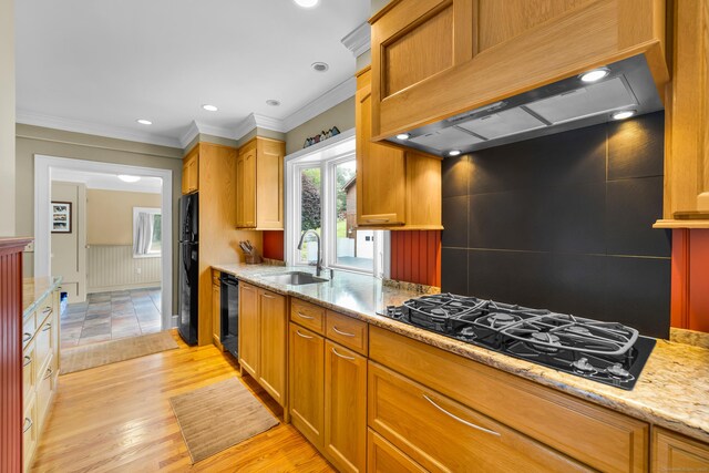 128 Holcomb Hill Rd, New Hartford, CT 06057 - kitchen featuring black appliances, wall chimney range hood, light wood-type flooring, light stone counters, and a wainscoted wall