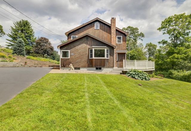 128 Holcomb Hill Rd, New Hartford, CT 06057 - rear view of house with a yard, a chimney, and a deck