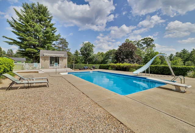128 Holcomb Hill Rd, New Hartford, CT 06057 - view of pool with a patio, a water slide, a diving board, an outbuilding, and view of wooded area