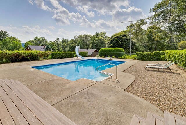 128 Holcomb Hill Rd, New Hartford, CT 06057 - view of swimming pool with a water slide, a patio, and view of scattered trees