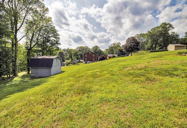 128 Holcomb Hill Rd, New Hartford, CT 06057 - view of grassy yard featuring a storage unit, a barn, and view of scattered trees