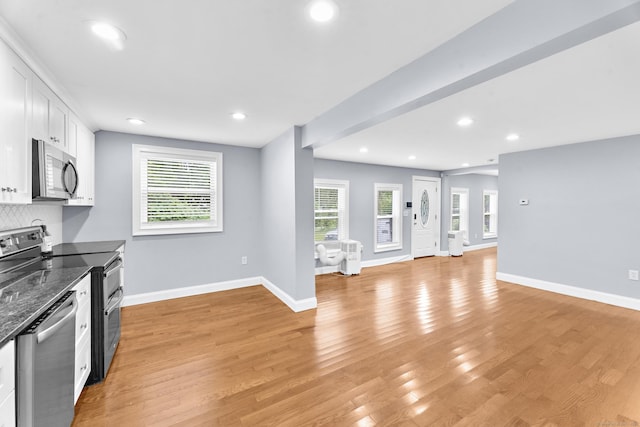 24 Main St, East Hampton, CT 06424 - kitchen with appliances with stainless steel finishes, light wood-type flooring, white cabinetry, recessed lighting, and backsplash