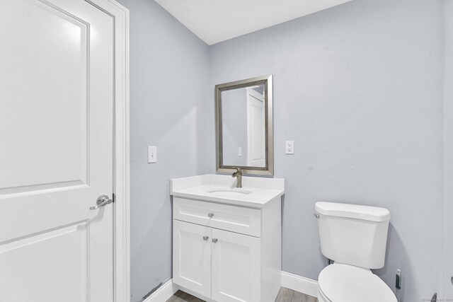 24 Main St, East Hampton, CT 06424 - half bath featuring vanity and wood finished floors