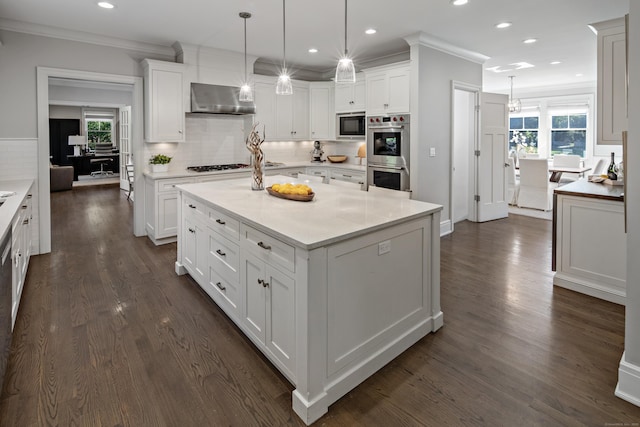 16 Gault Park Dr, Westport, CT 06880 - kitchen featuring double oven, built in microwave, extractor fan, white cabinetry, and ornamental molding