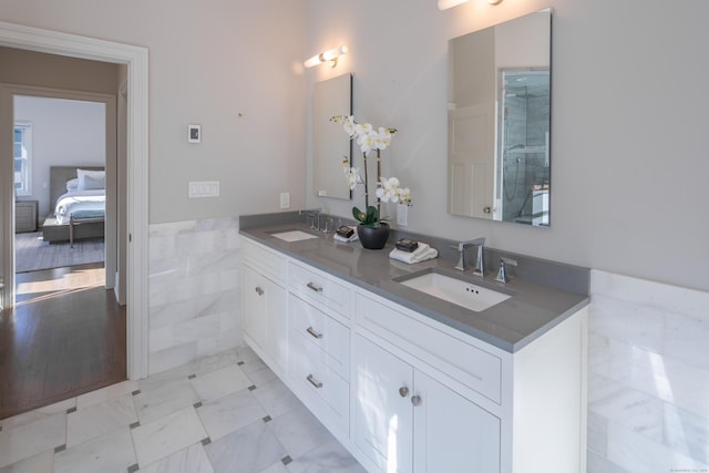 16 Gault Park Dr, Westport, CT 06880 - ensuite bathroom with double vanity, a wainscoted wall, and tile walls