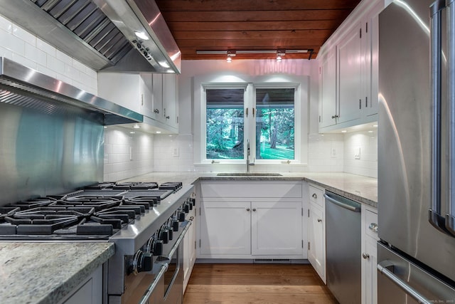 60 Ferry Bridge Rd, Washington, CT 06793 - kitchen with appliances with stainless steel finishes, wall chimney range hood, rail lighting, white cabinets, and wooden ceiling