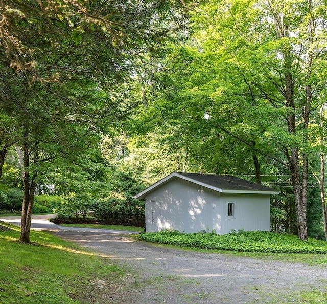 60 Ferry Bridge Rd, Washington, CT 06793 - view of home's exterior with an outdoor structure and a view of trees