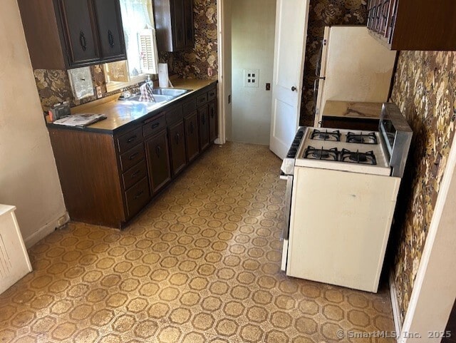 276 Spencer St, Naugatuck, CT 06770 - kitchen with white appliances, dark brown cabinets, and light flooring