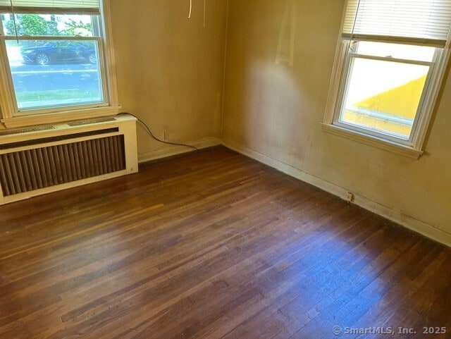 276 Spencer St, Naugatuck, CT 06770 - unfurnished room featuring plenty of natural light, dark wood-type flooring, and radiator