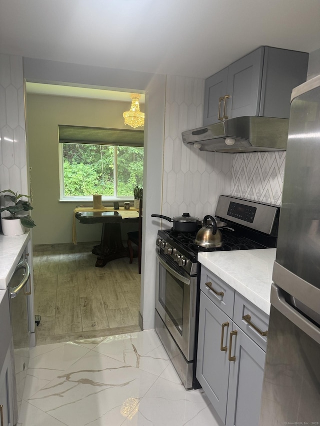 37 Brookwood Dr Apt D, Rocky Hill, CT 06067 - kitchen with stainless steel appliances, light countertops, gray cabinetry, and tasteful backsplash