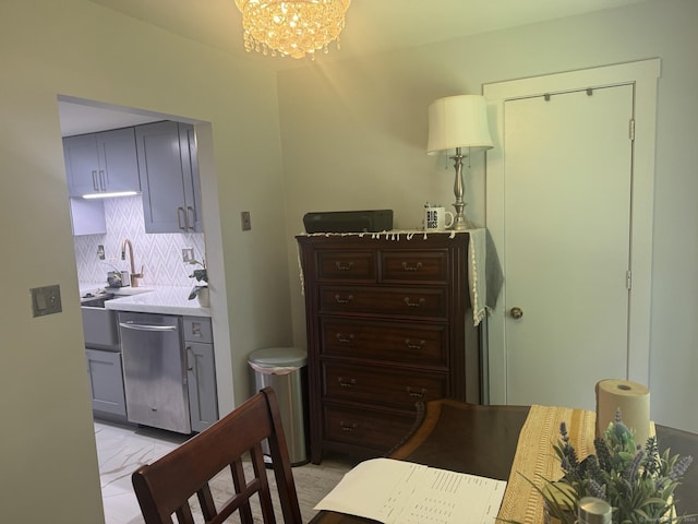 37 Brookwood Dr Apt D, Rocky Hill, CT 06067 - kitchen with stainless steel dishwasher, a chandelier, tasteful backsplash, gray cabinets, and light marble finish flooring
