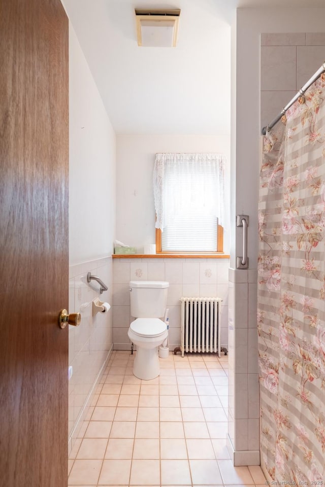 270 Decicco Rd, Waterbury, CT 06705 - bathroom featuring radiator heating unit, tile walls, lofted ceiling, tile patterned floors, and a shower with shower curtain