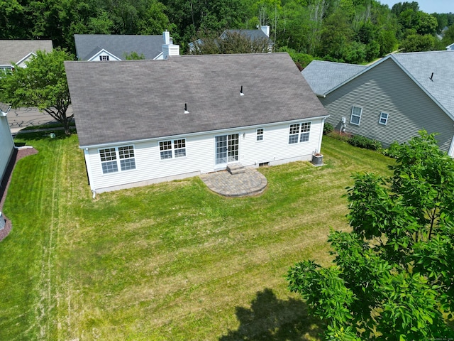 46 Rolling Grn, Middletown, CT 06457 - rear view of house featuring a shingled roof, a yard, a chimney, and a patio