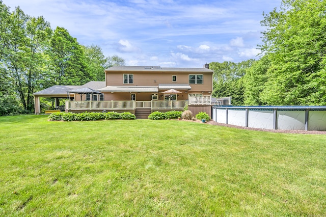 15 Quigley Rd, Wallingford, CT 06492 - rear view of property with a wooden deck, a chimney, an outdoor pool, and a lawn