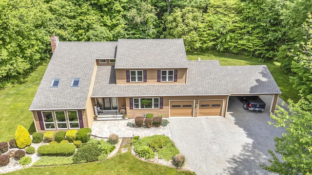 15 Quigley Rd, Wallingford, CT 06492 - view of front of home with an attached garage, driveway, a chimney, roof with shingles, and a front lawn