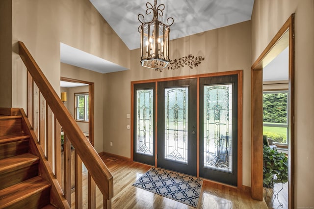 15 Quigley Rd, Wallingford, CT 06492 - foyer entrance featuring a chandelier, stairway, wood finished floors, and high vaulted ceiling