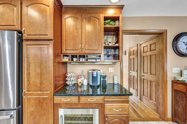 15 Quigley Rd, Wallingford, CT 06492 - kitchen with freestanding refrigerator, open shelves, beverage cooler, dark stone counters, and brown cabinets