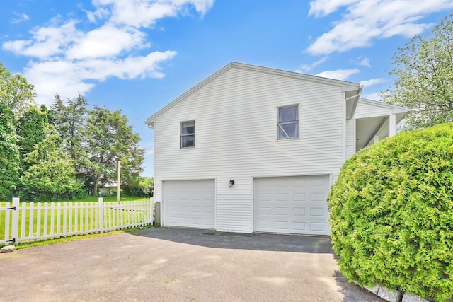 9 Renee Ln, Enfield, CT 06082 - view of side of home featuring driveway and a garage
