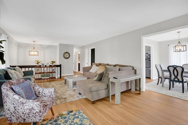 9 Renee Ln, Enfield, CT 06082 - living room with a chandelier and light wood-style flooring