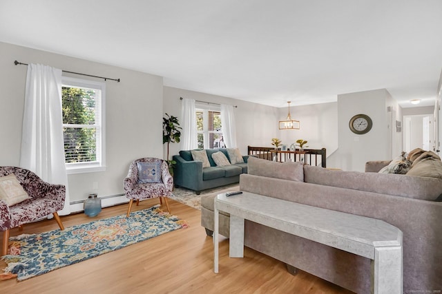 9 Renee Ln, Enfield, CT 06082 - living area featuring wood finished floors, healthy amount of natural light, and a chandelier