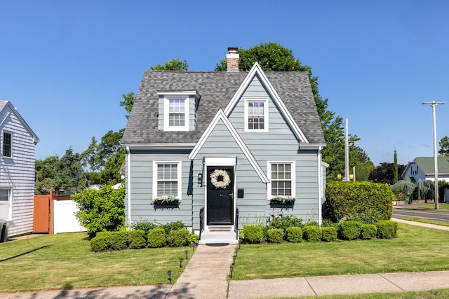 32 Holcomb St, West Haven, CT 06516 - view of front of home featuring a chimney and roof with shingles
