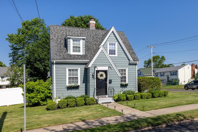32 Holcomb St, West Haven, CT 06516 - view of front of property featuring roof with shingles and a chimney