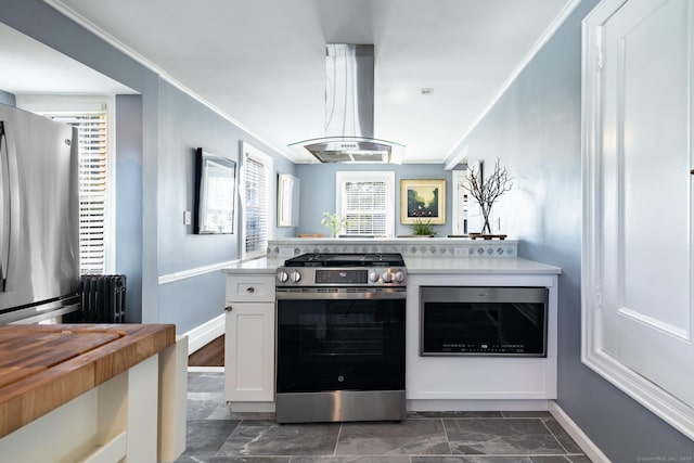 32 Holcomb St, West Haven, CT 06516 - kitchen with stainless steel appliances, radiator, exhaust hood, ornamental molding, and white cabinets