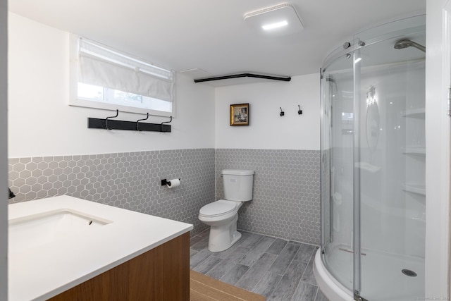 32 Holcomb St, West Haven, CT 06516 - full bath with tile walls, a stall shower, vanity, wood finished floors, and a wainscoted wall