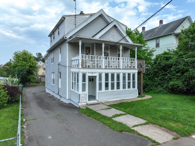29 Olive St, New Britain, CT 06051 - view of front of home featuring a balcony, driveway, and a front lawn