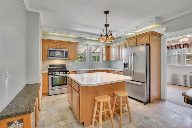 171 Lincoln St, Middletown, CT 06457 - kitchen with appliances with stainless steel finishes, radiator heating unit, a center island, a chandelier, and stone finish flooring