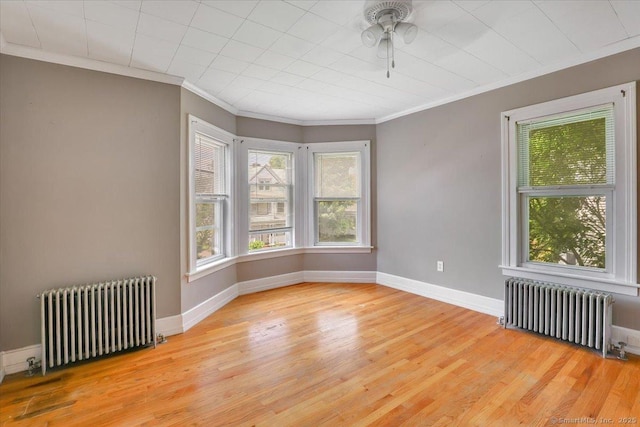 171 Lincoln St, Middletown, CT 06457 - empty room with radiator, wood finished floors, ornamental molding, and ceiling fan