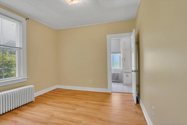 171 Lincoln St, Middletown, CT 06457 - empty room with radiator, light wood finished floors, and ornamental molding
