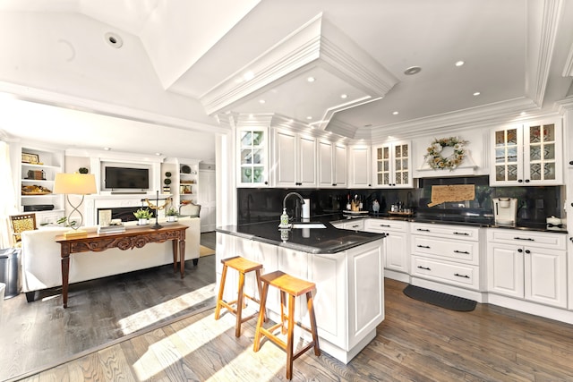 46 Tally Ho Rd, Ridgefield, CT 06877 - kitchen featuring dark countertops, white cabinets, a breakfast bar area, backsplash, and glass insert cabinets