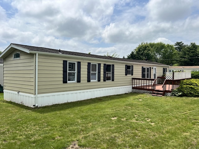 26 Jacqueline Ln, Windham, CT 06256 - back of property with a wooden deck and a lawn