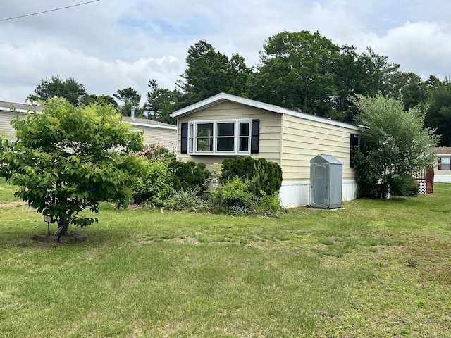 26 Jacqueline Ln, Windham, CT 06256 - view of side of home featuring a yard