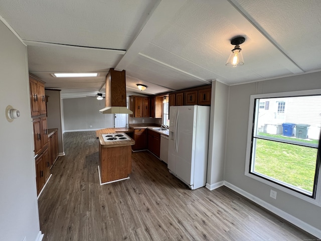 26 Jacqueline Ln, Windham, CT 06256 - kitchen featuring white appliances, exhaust hood, dark wood-style floors, vaulted ceiling, and light countertops