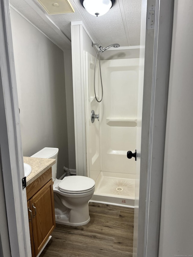 26 Jacqueline Ln, Windham, CT 06256 - bathroom with wood finished floors, a textured ceiling, a shower stall, and vanity