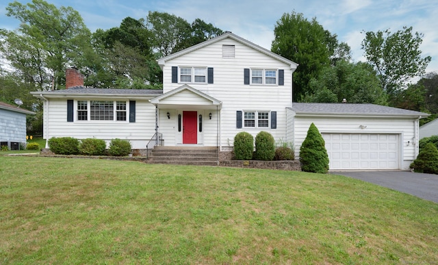 140 Braeside Dr, Hamden, CT 06514 - view of front of property with driveway, a garage, a front yard, and a chimney