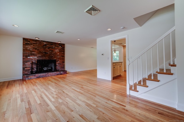 140 Braeside Dr, Hamden, CT 06514 - unfurnished living room with light wood-type flooring, stairway, a fireplace, and recessed lighting