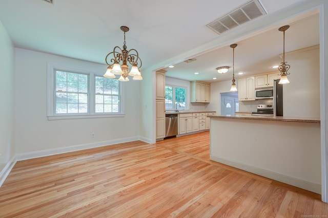 140 Braeside Dr, Hamden, CT 06514 - kitchen with stainless steel appliances, light wood-style flooring, a chandelier, pendant lighting, and recessed lighting