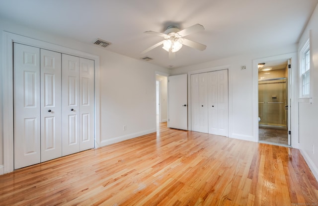 140 Braeside Dr, Hamden, CT 06514 - unfurnished bedroom featuring two closets, light wood-type flooring, connected bathroom, and ceiling fan