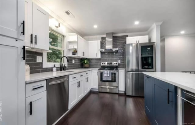 17 Kingsbury Rd, Norwalk, CT 06851 - kitchen with wall chimney range hood, stainless steel appliances, backsplash, light countertops, and recessed lighting