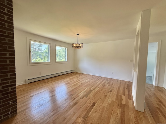 249 Wall St, Hebron, CT 06248 - empty room featuring a baseboard heating unit, a chandelier, and light wood-type flooring